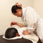 Therapist performing Traditional Chinese massage Tysons Corner, focusing on relaxation, pain relief, and energy balance through ancient healing techniques.